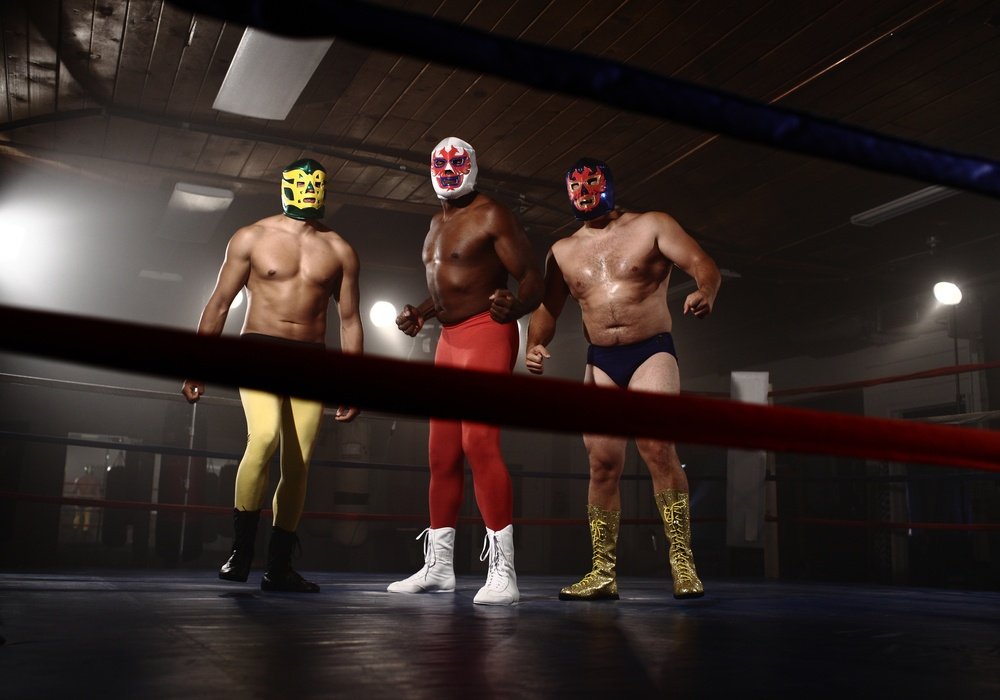 Three,Masked,Wrestlers,Stand,In,Ring